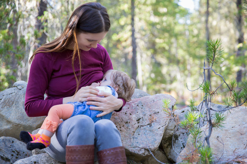 woman breastfeeding in a woodland