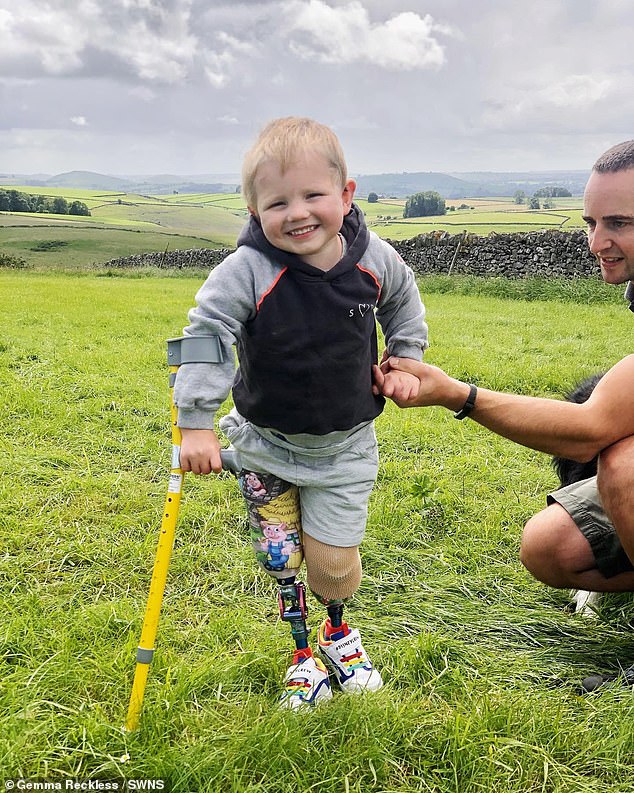 Smiling face of determination: William Reckless gives a cheeky grin as he takes trip to the great outdoors with father Michael , and his family