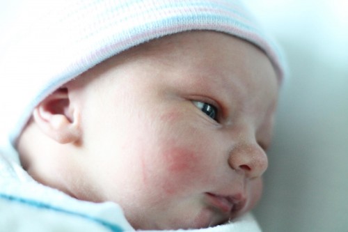 newborn baby looking to the side